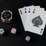 playing cards and dice on a black table